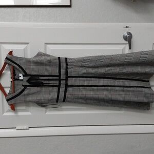 A Liza Luxe plaid sleeveless dress. Black / White plaid with black trim.size m
